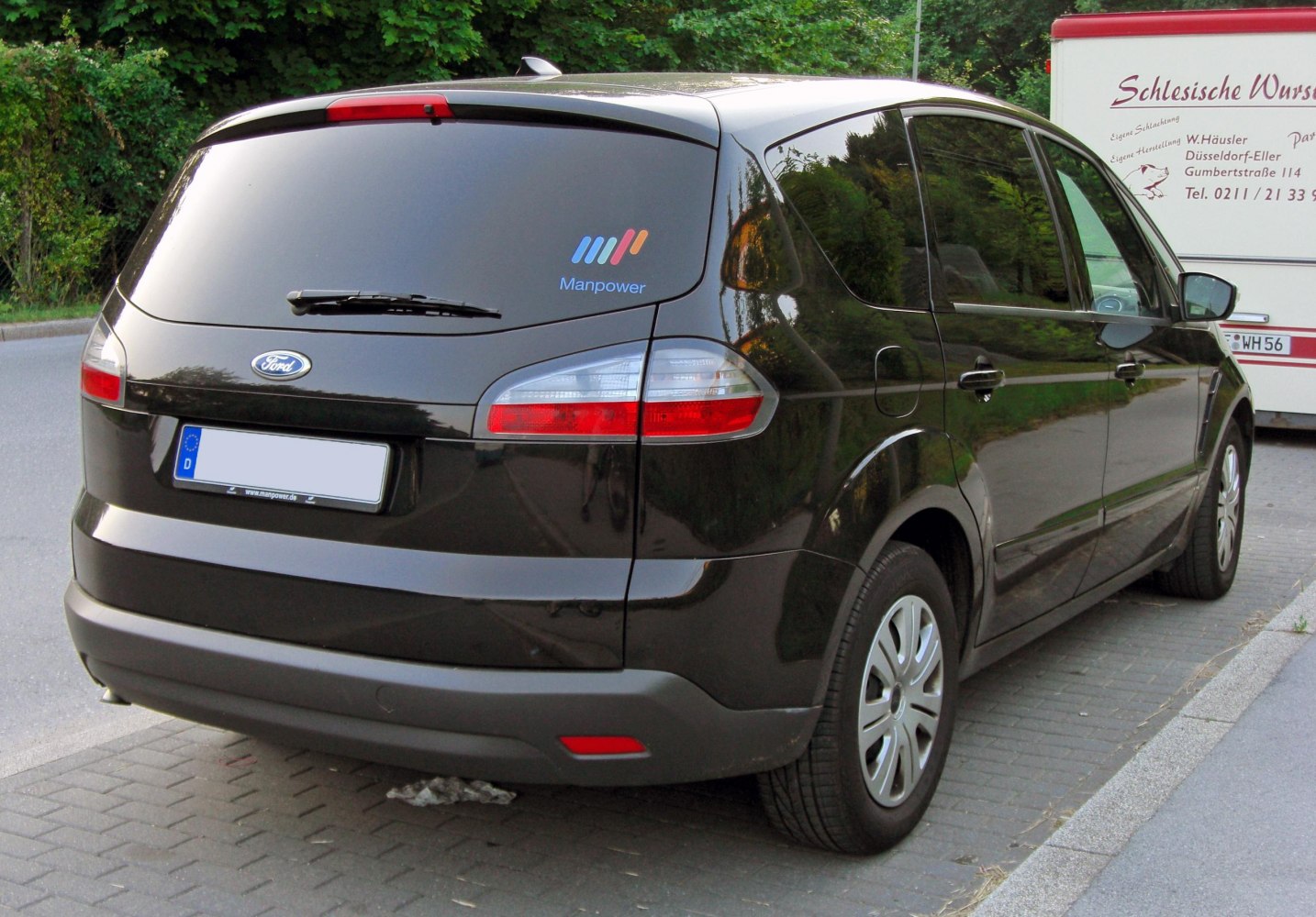 Rear view of MPV with distinctive tail lights and rear wiper