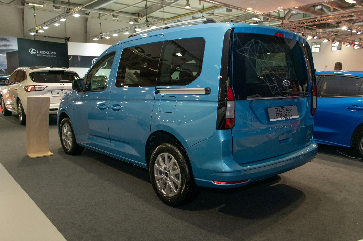 Rear and side view of a blue MPV with alloy wheels and sliding doors
