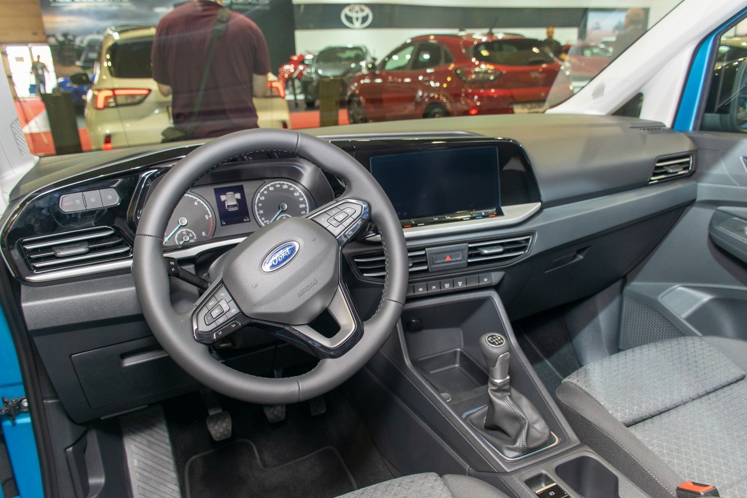 Interior dashboard, steering wheel, manual gear shift, infotainment screen