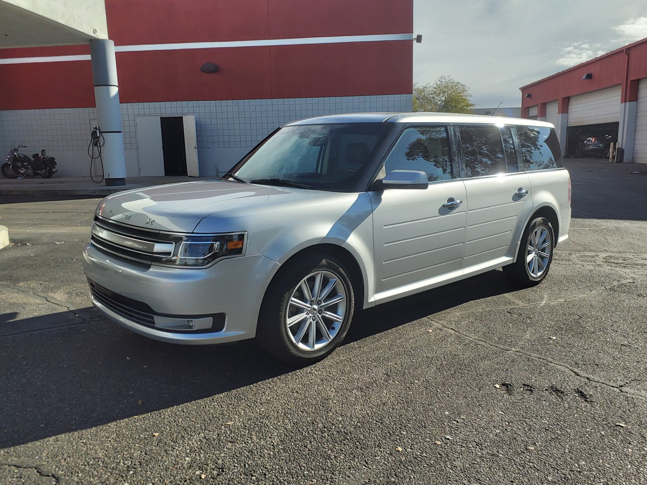 Silver 7-seater SUV with boxy design and front grille