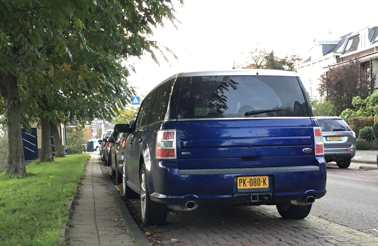 Rear view of boxy SUV with dual exhaust pipes and tow hitch