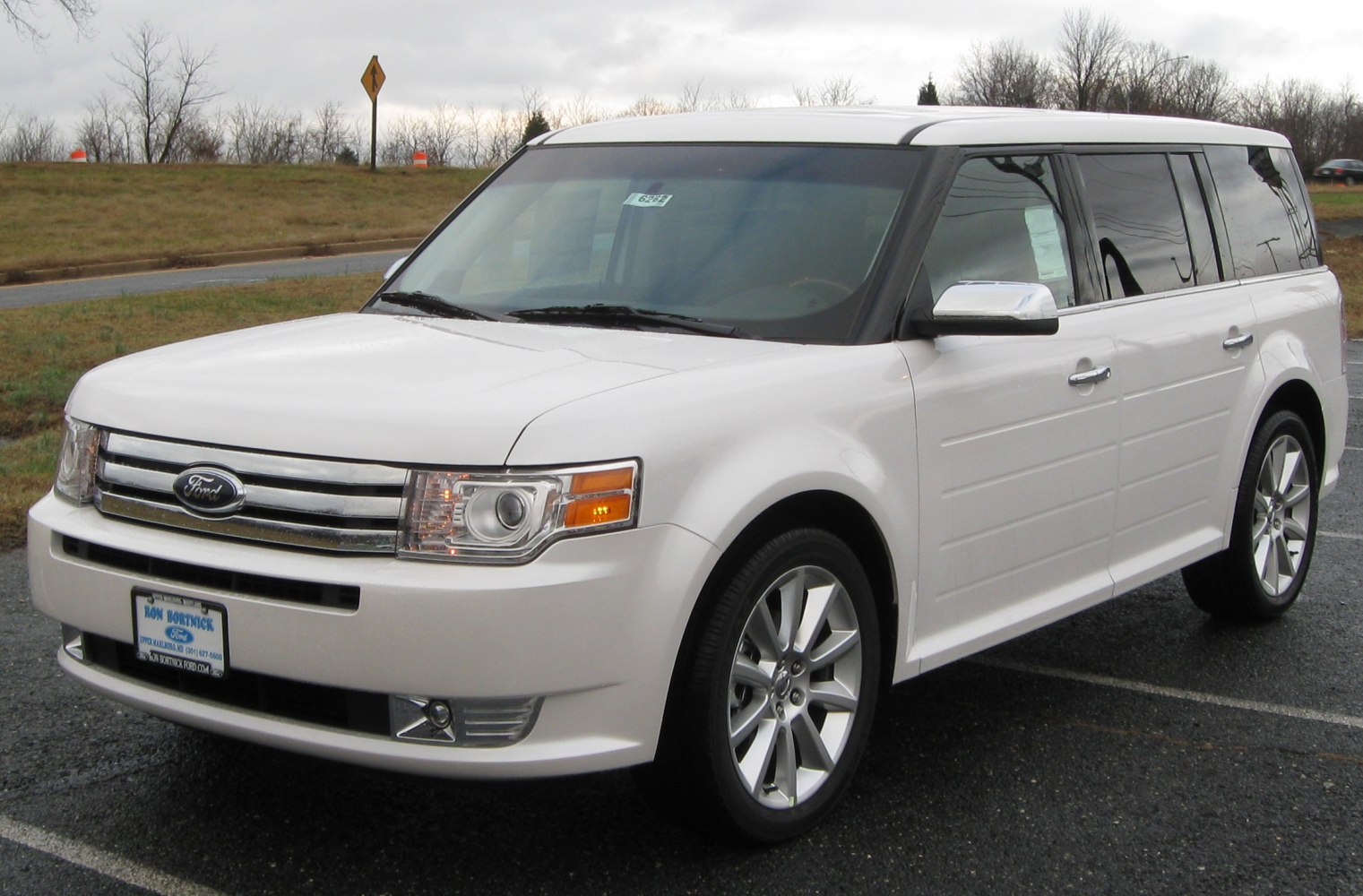 Boxy white SUV front and side with chrome grille and tinted windows
