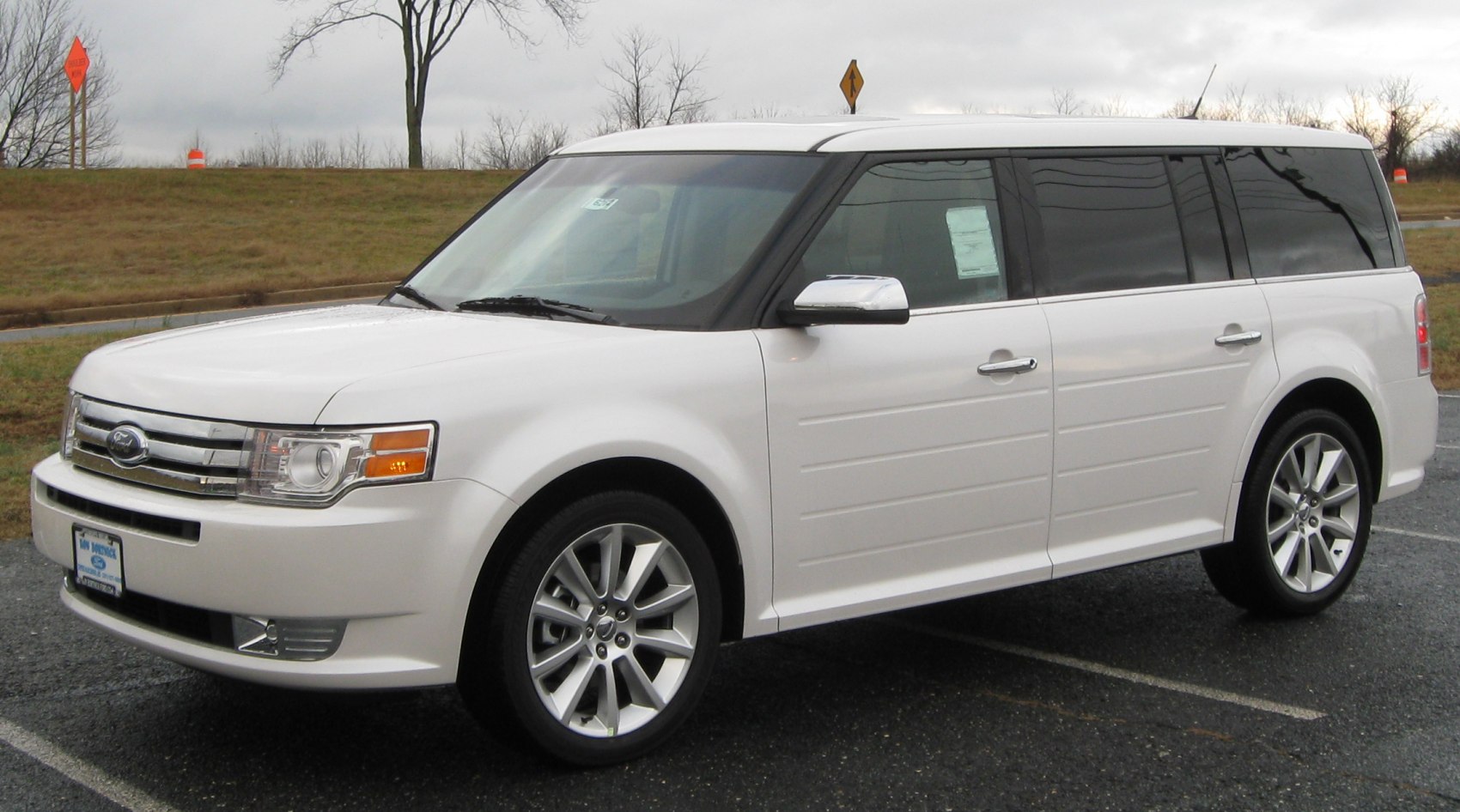 White boxy station wagon with alloy wheels and large tinted windows