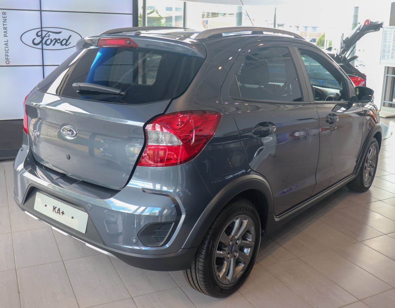 Rear side view of a raised hatchback with rugged body cladding and taillights.
