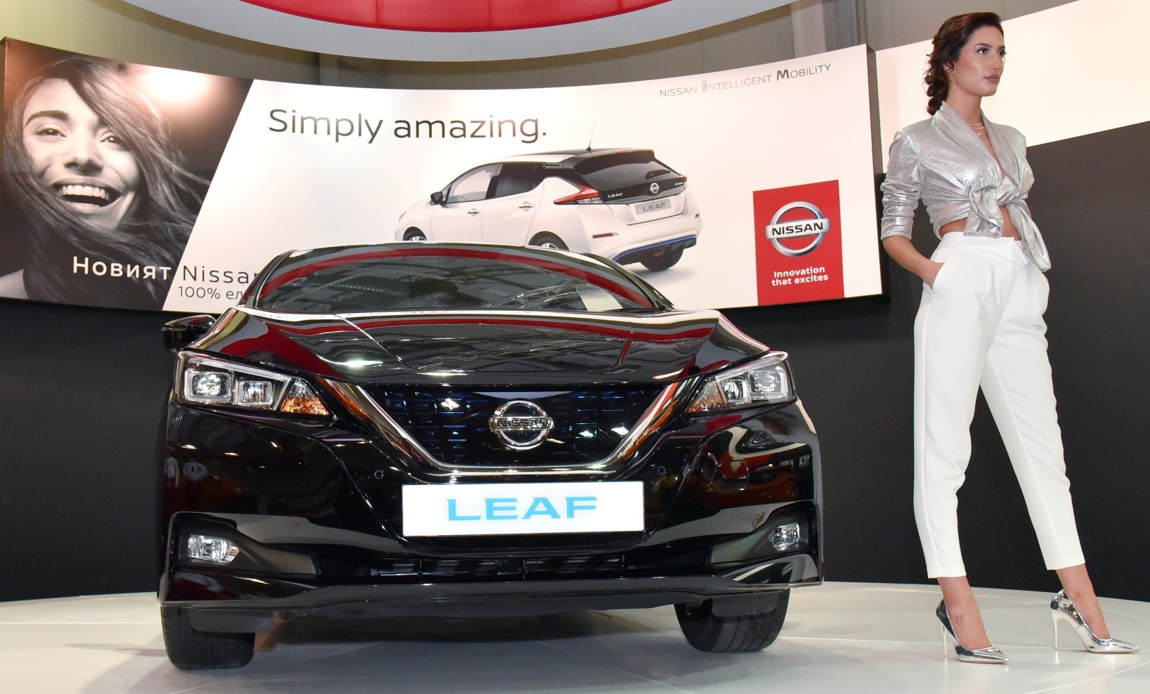 Front view of an electric vehicle showcasing LED headlights and a glossy black finish