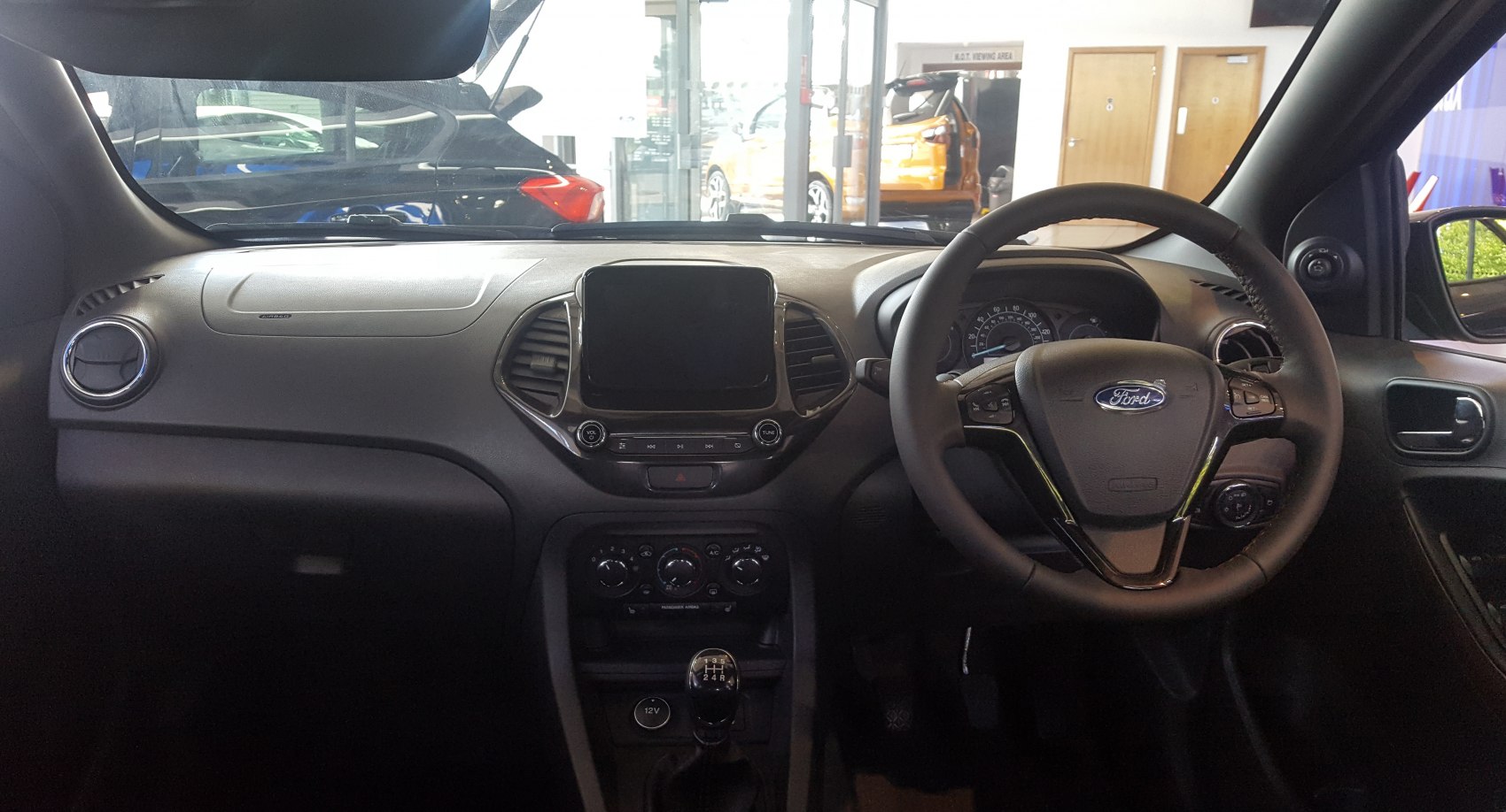 Dashboard and steering wheel with touchscreen and manual gear shifter