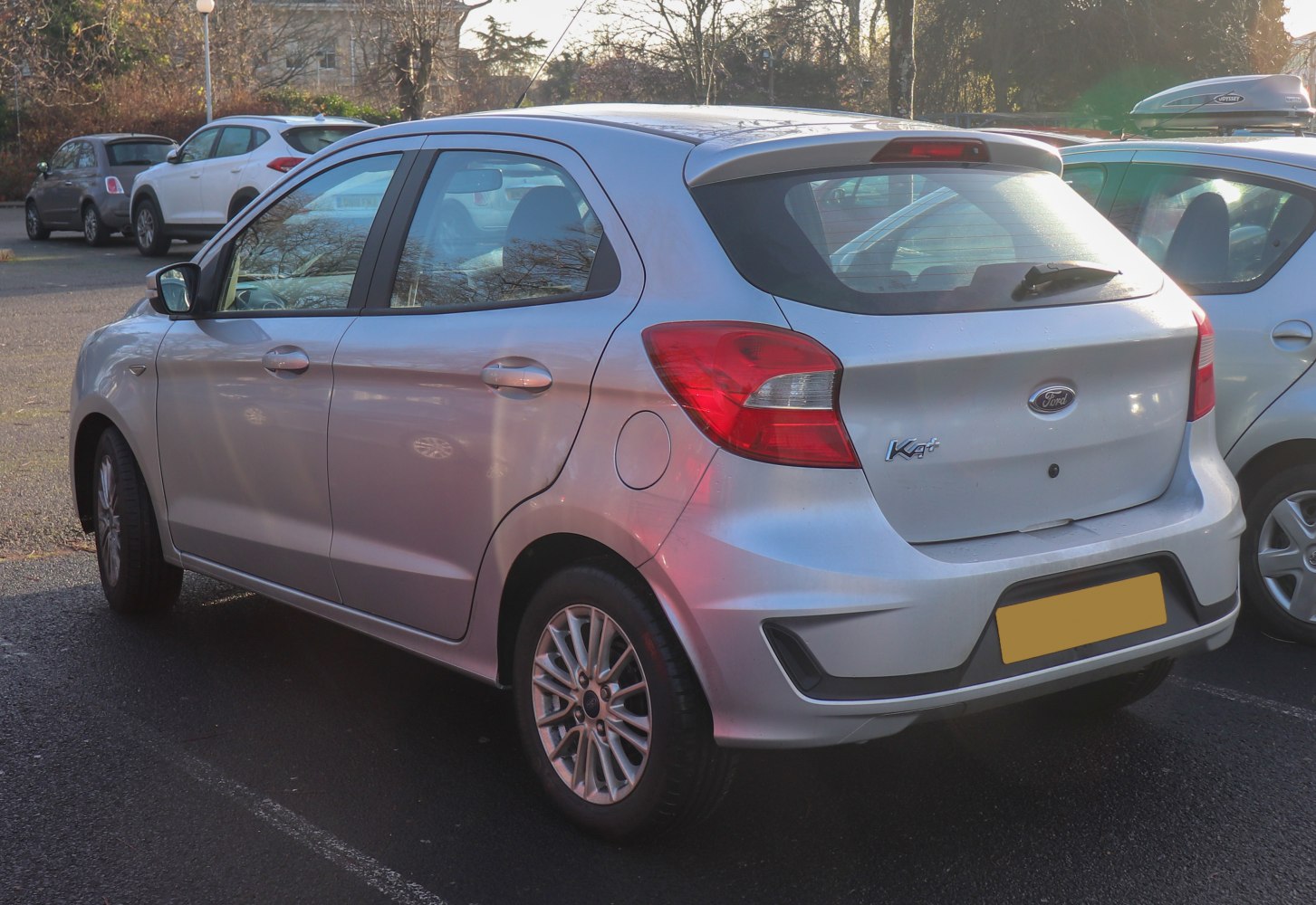 Silver small hatchback rear side with taillights and alloy wheels