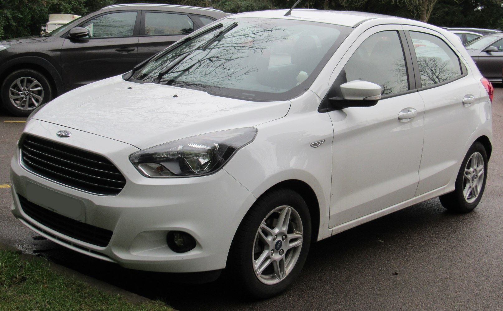 White compact hatchback with sleek grille and angular headlights