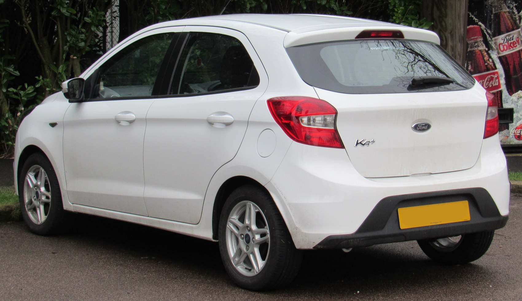Rear view of a small hatchback showing tail lights and alloy wheels