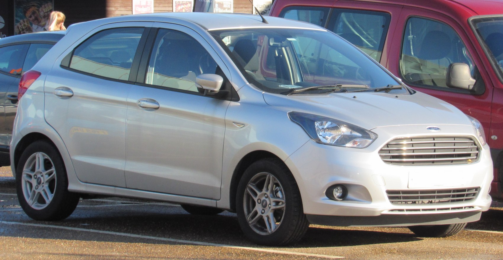 Silver compact hatchback with horizontal bar grille and angular headlights