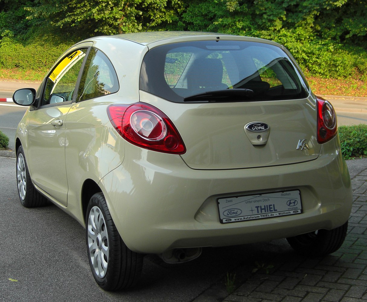 Rear view of compact hatchback with large round taillights and smooth body curves