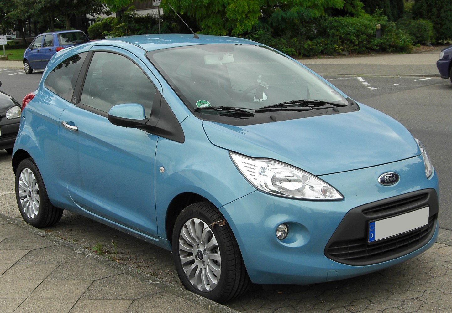 Compact blue 3-door hatchback with rounded headlights and alloy wheels.