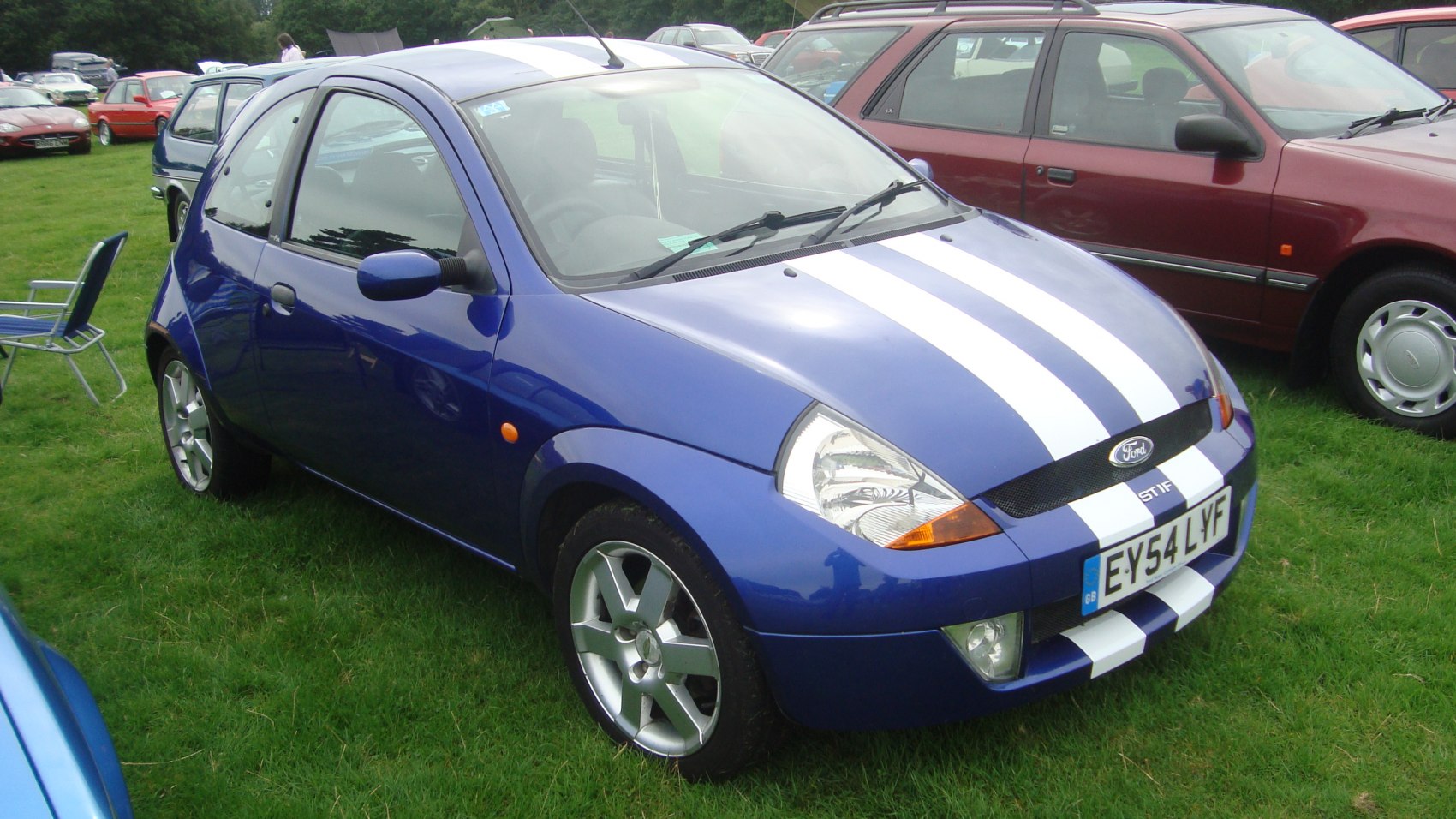 Compact hatchback with front racing stripes and alloy wheels