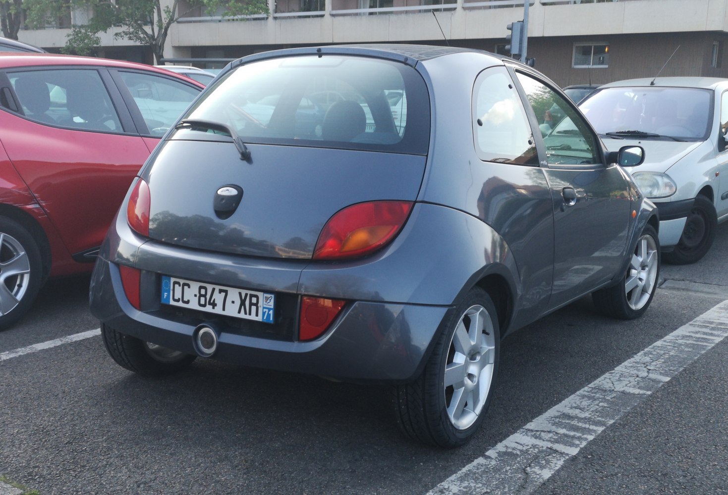 Rear view of a compact hatchback with unique tail lights and center exhaust.
