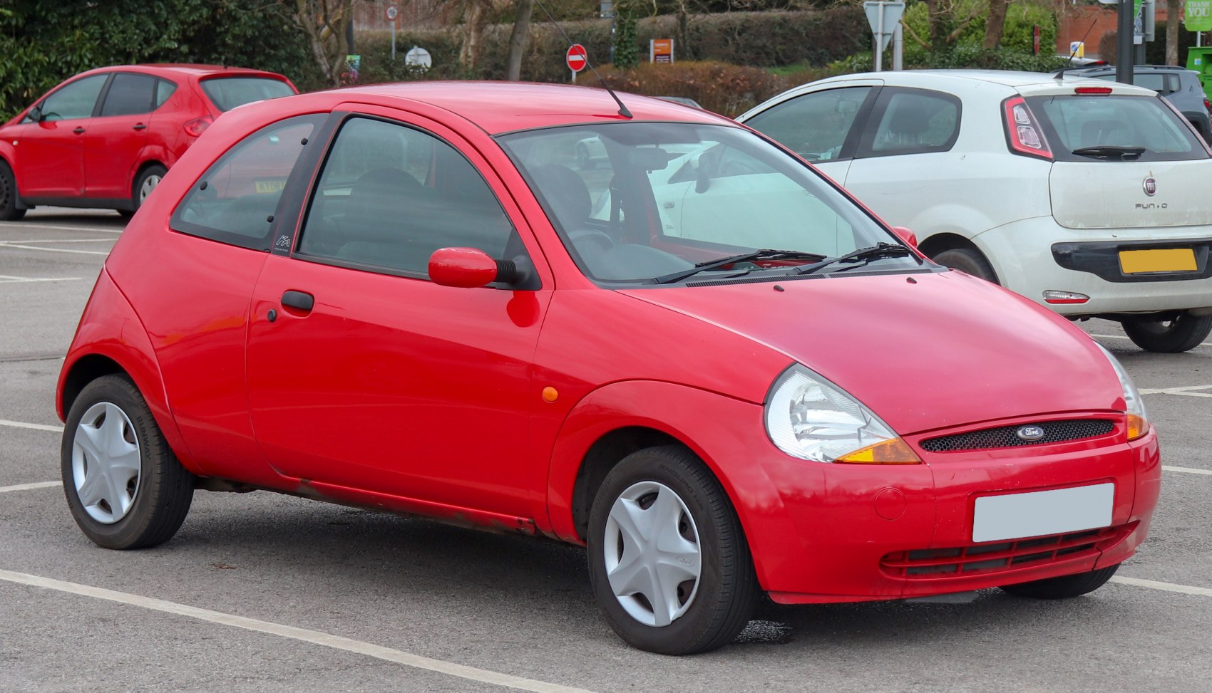 Red compact hatchback with distinctive rounded shape and two-door layout