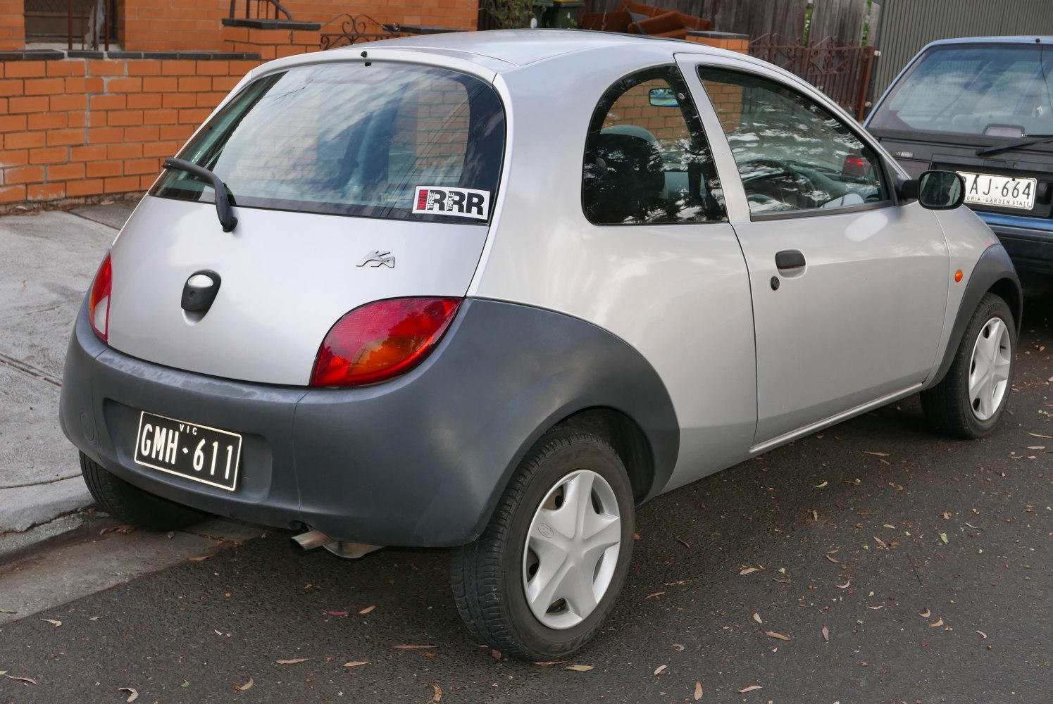 Compact hatchback rear view with rear window wiper and distinctive rounded design