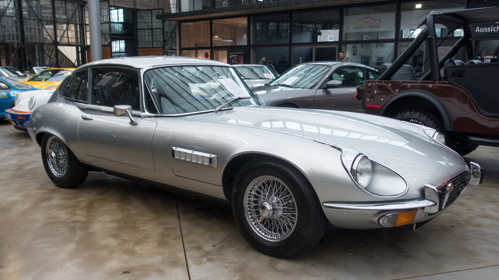 Silver classic coupe with wire wheels and curved body
