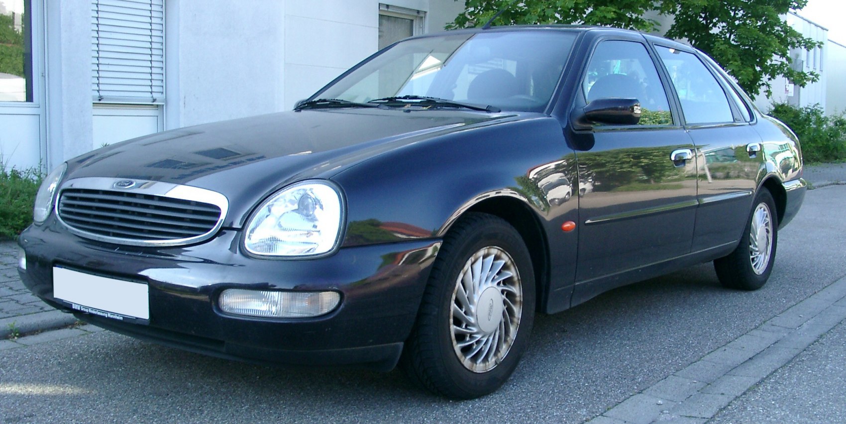 Front grille, rounded headlights, sedan side profile