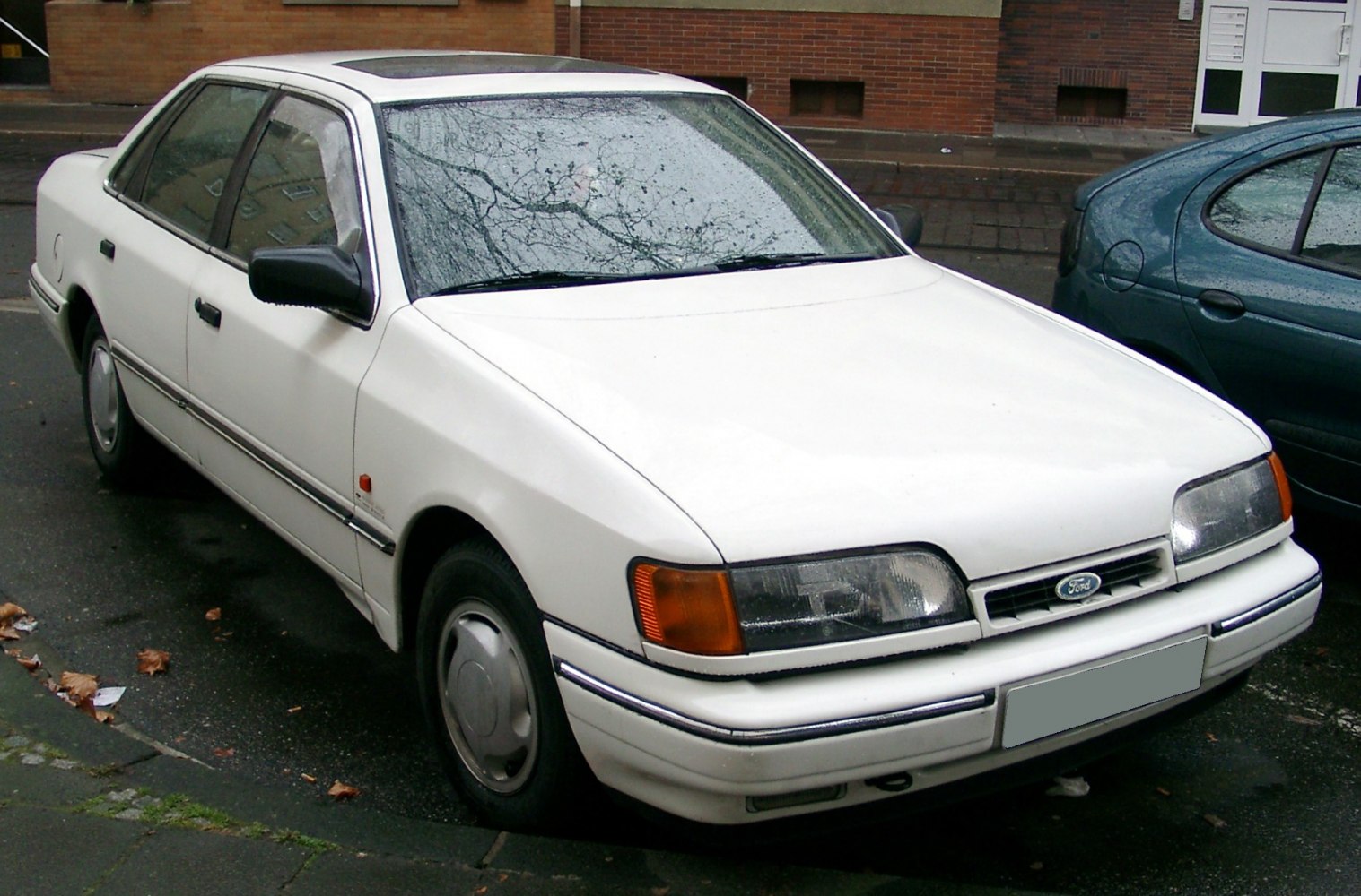 White sedan with rectangular headlights and streamlined 80s design