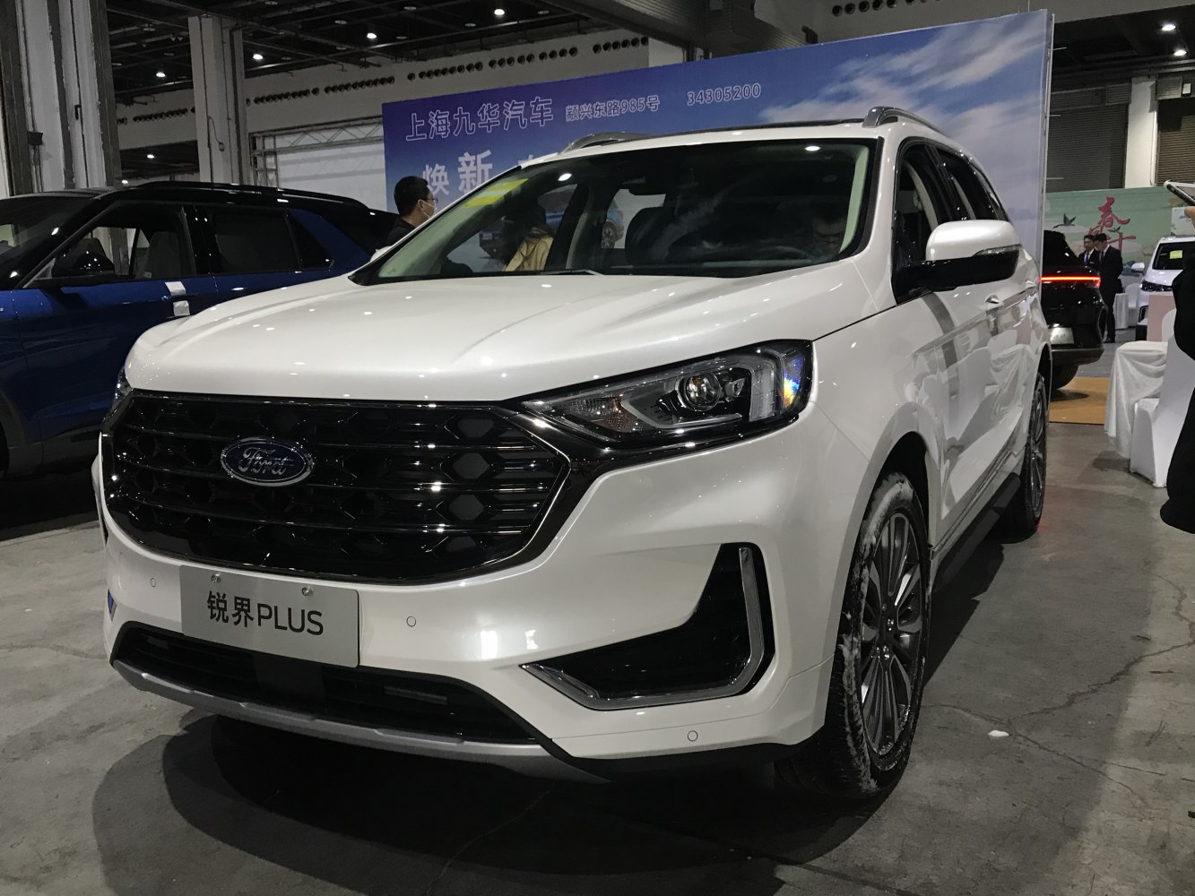 White SUV front with black honeycomb grille and LED headlights