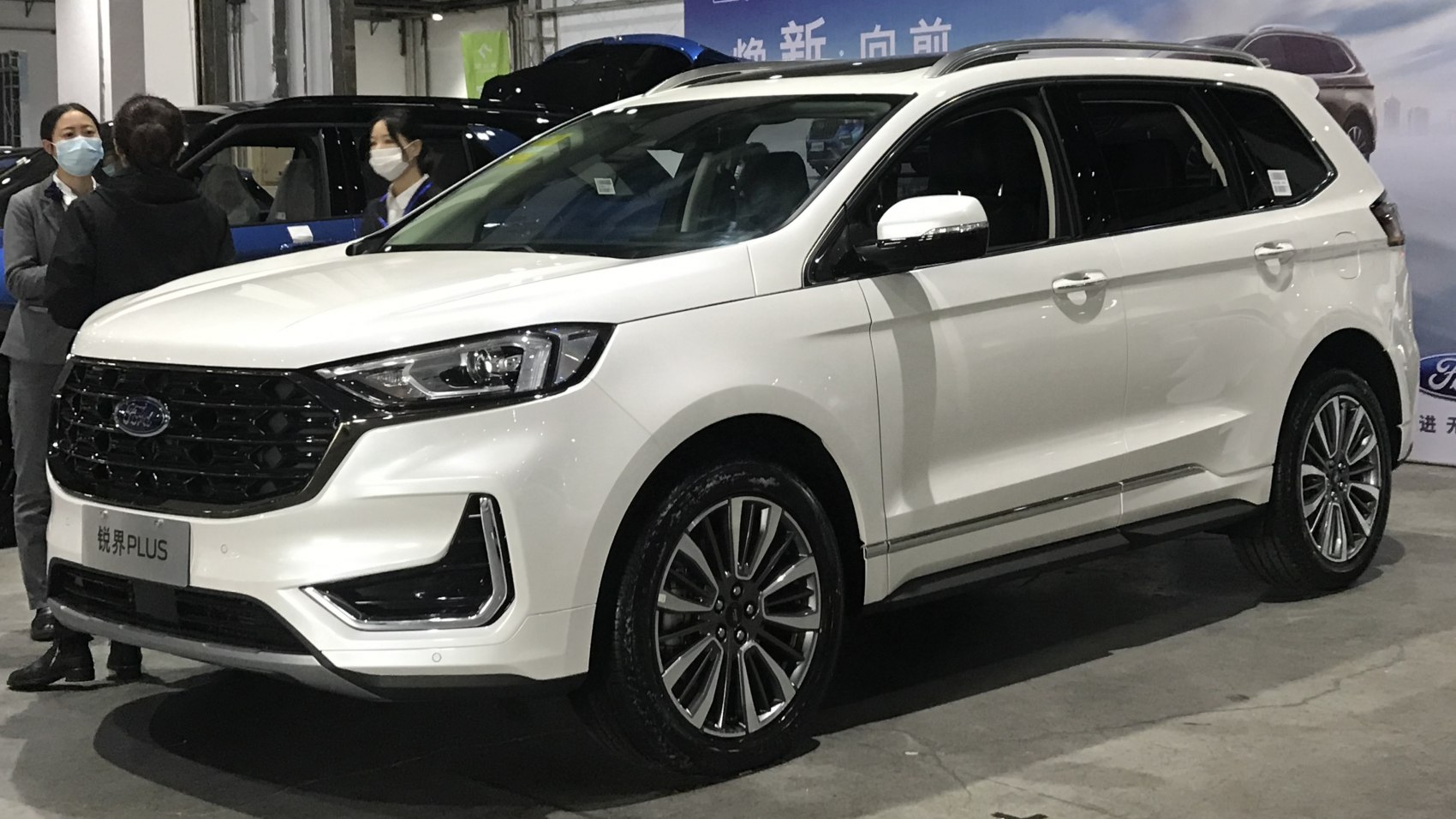 White SUV with black honeycomb grille and sleek LED headlights
