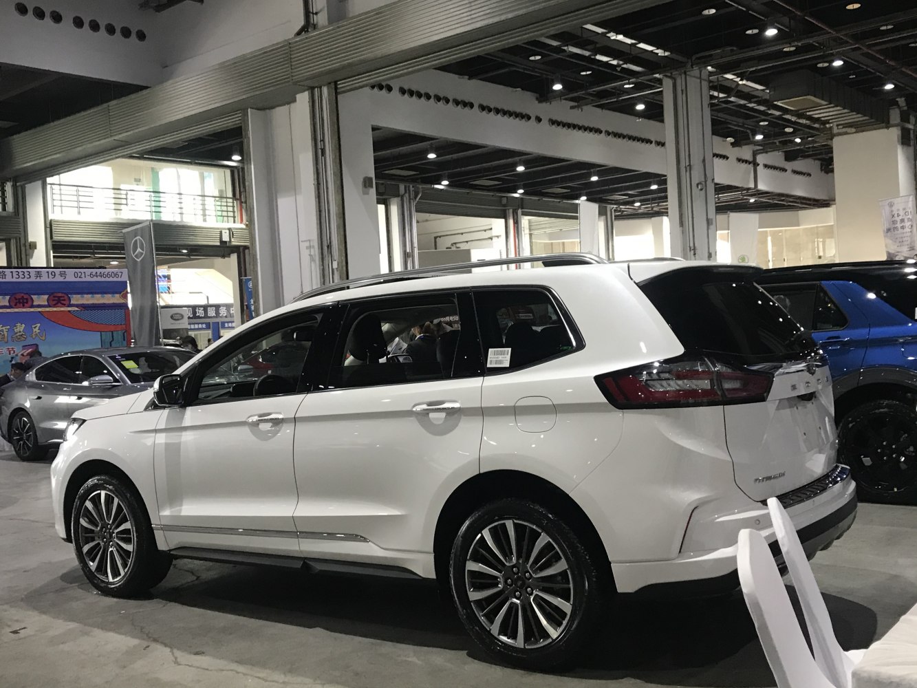 White SUV showing side and rear exterior with alloy wheels and roof rails