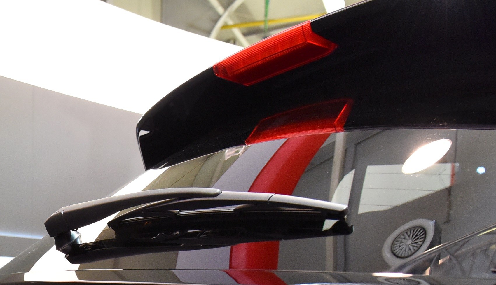 Rear window wiper and red integrated spoiler on hatchback rear