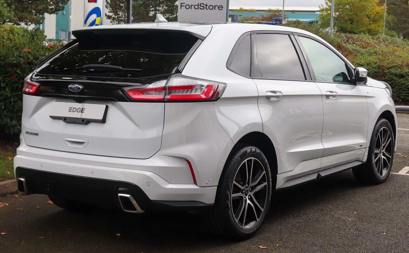 Rear and side profile of white SUV with sport exhausts and alloy wheels