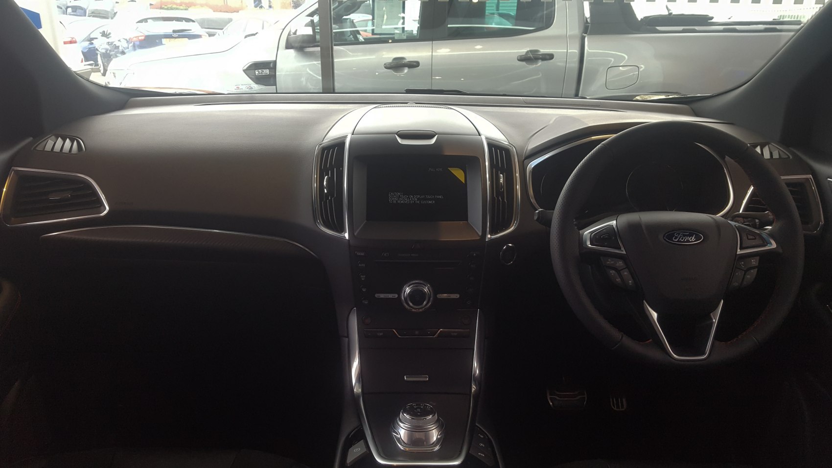 Dashboard and steering wheel with central infotainment display