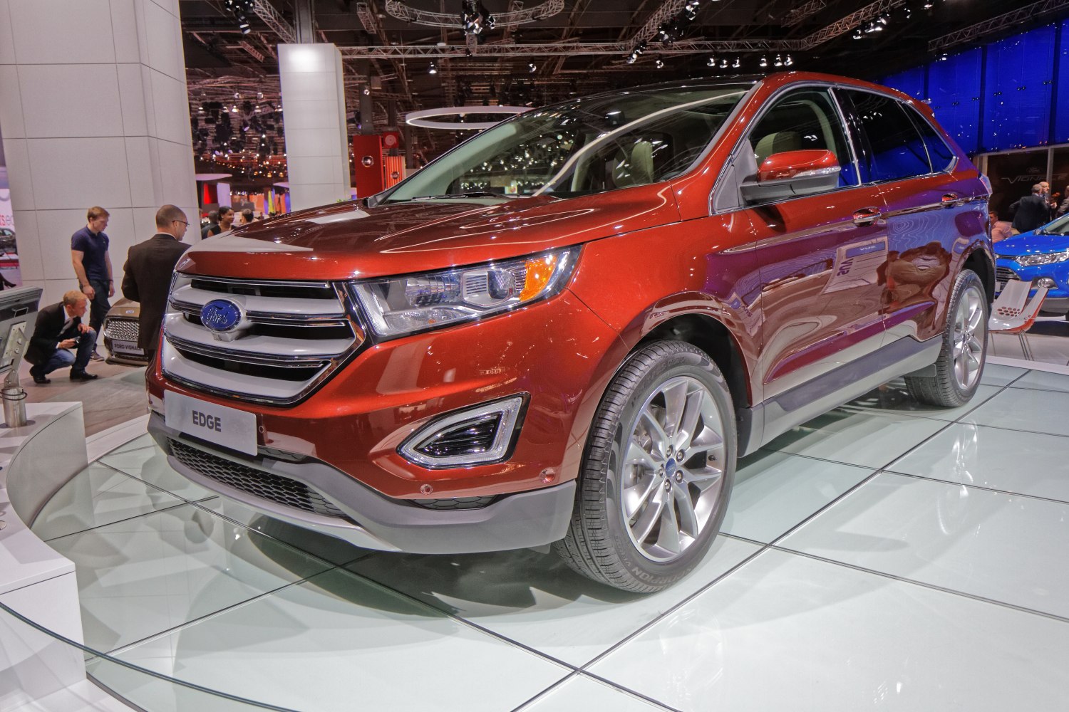 Front side view of red SUV showing grille and lights