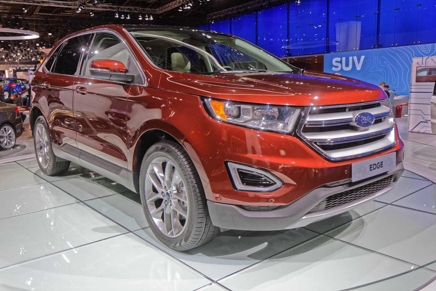 Front-side view of SUV with chrome grille and sharp headlights