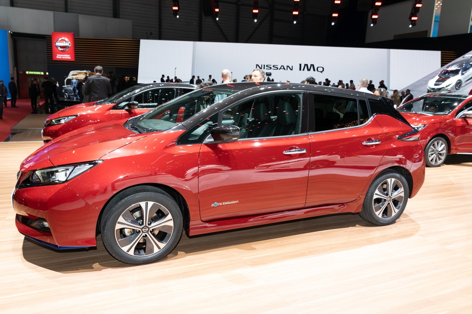 Side profile of red electric hatchback with distinctive wheels and body lines