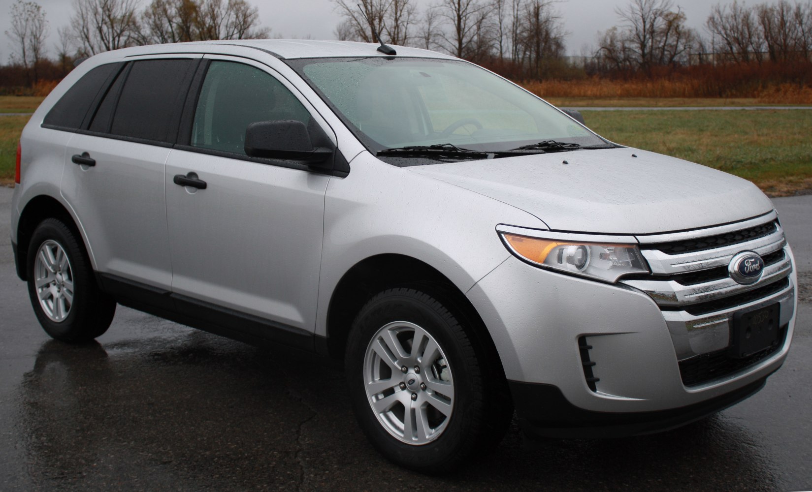 Silver SUV front-side view with chrome grille and headlights