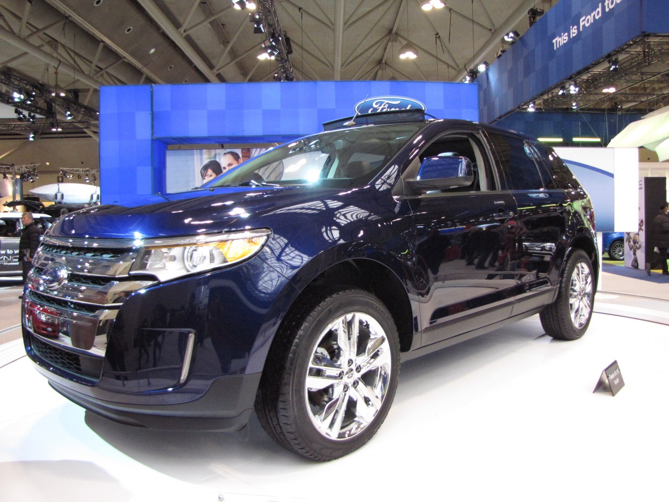 Front side view of SUV with chrome grille and alloy wheels
