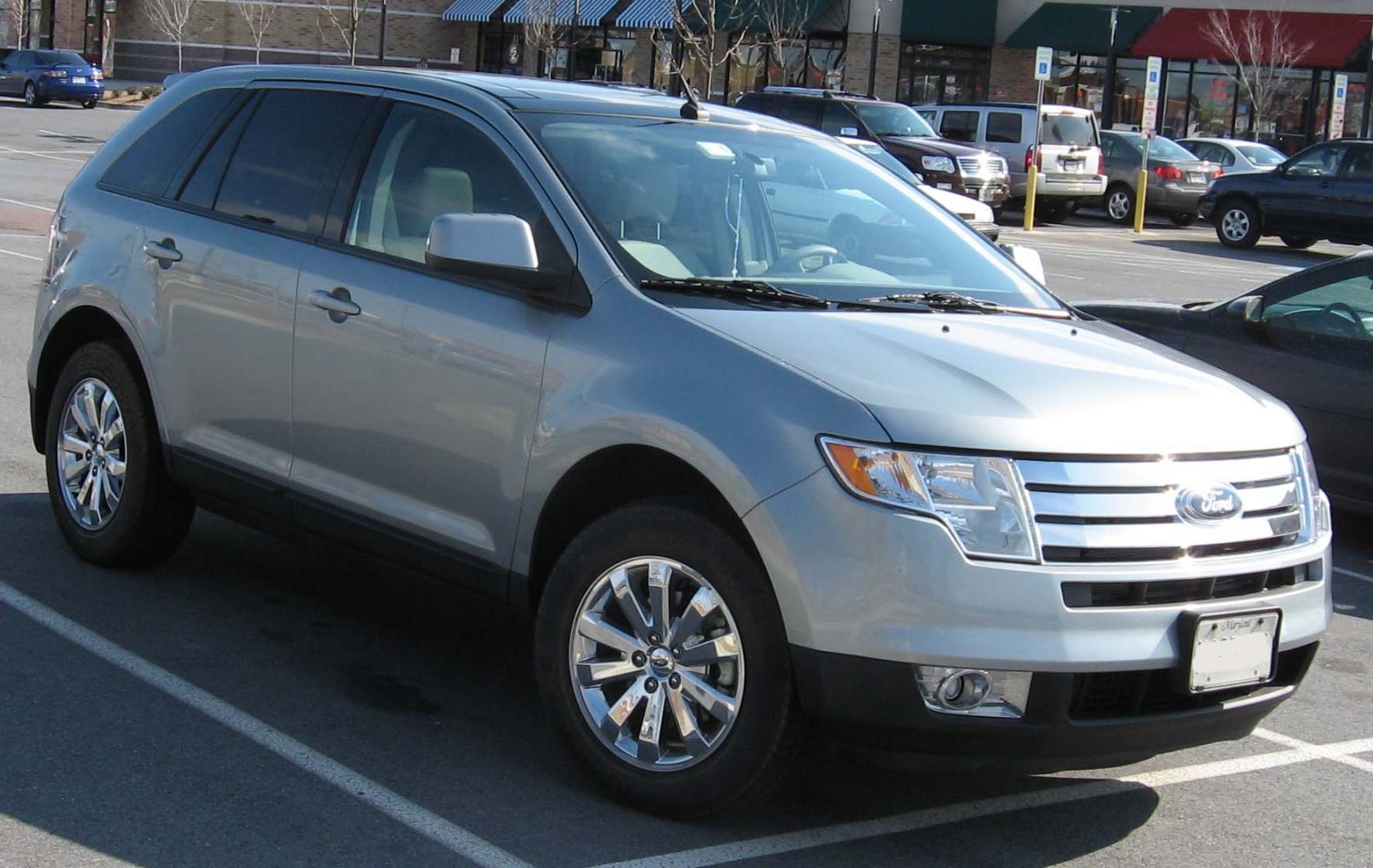 Silver SUV front side profile with chrome grille and multi-spoke wheels