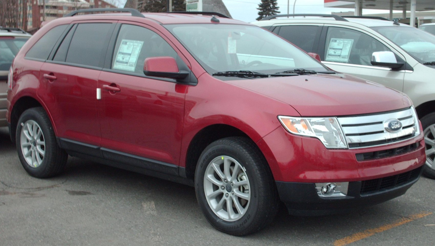 Red mid-size SUV with chrome grille and alloy wheels front side view
