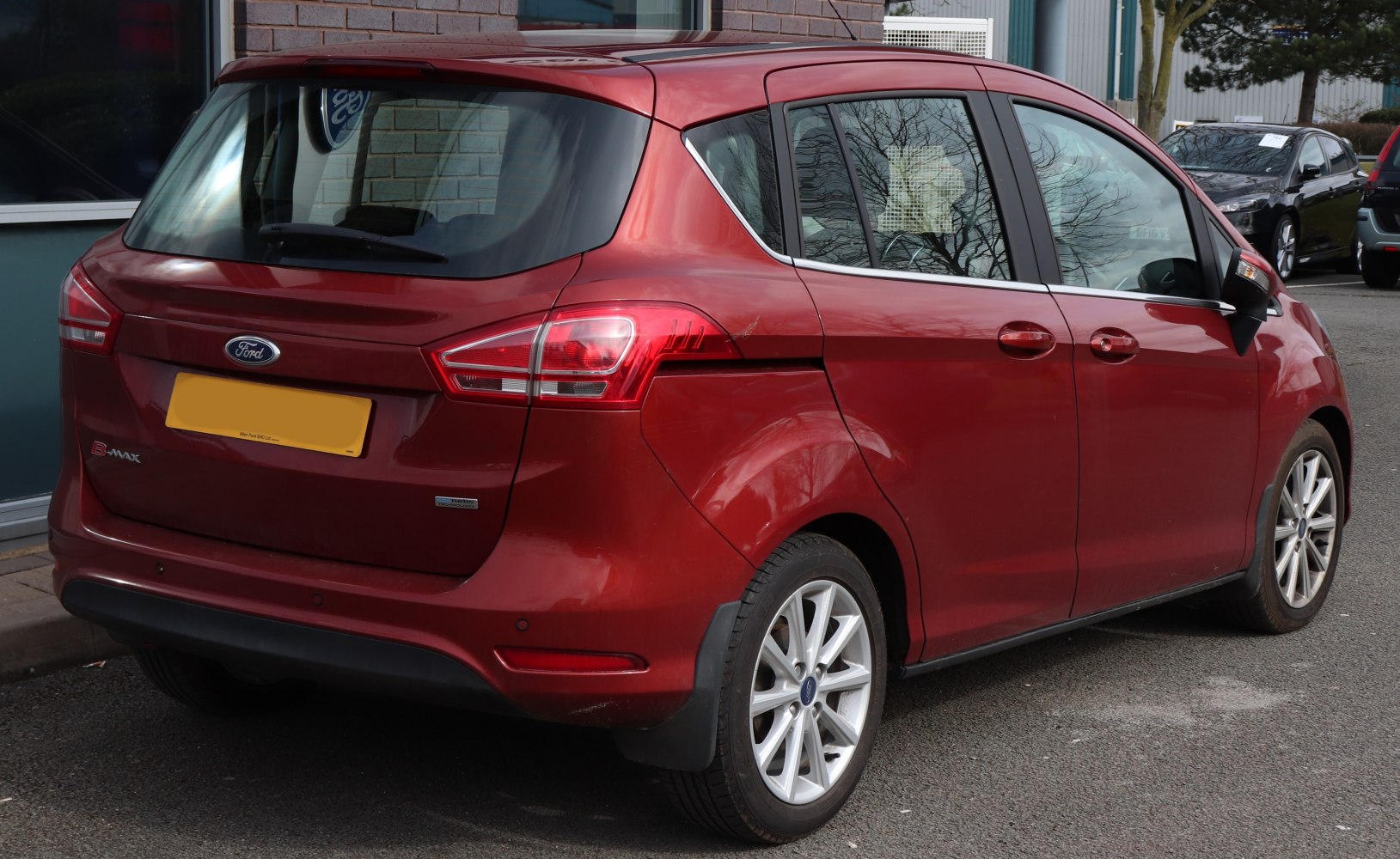 Rear side view with sliding doors and modern taillights