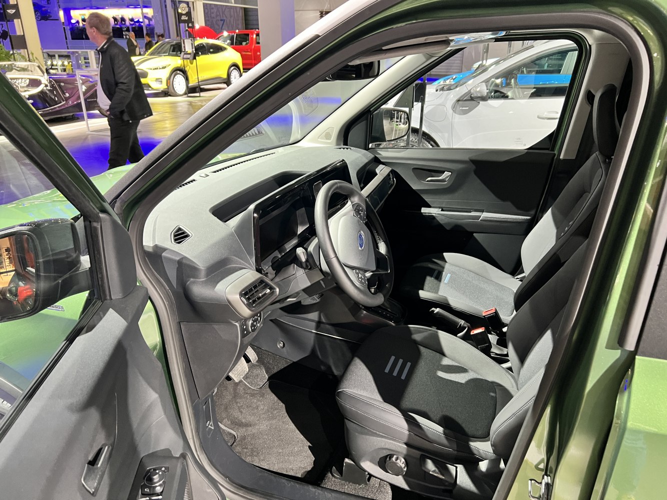 Interior view with dashboard, steering wheel, and front seats