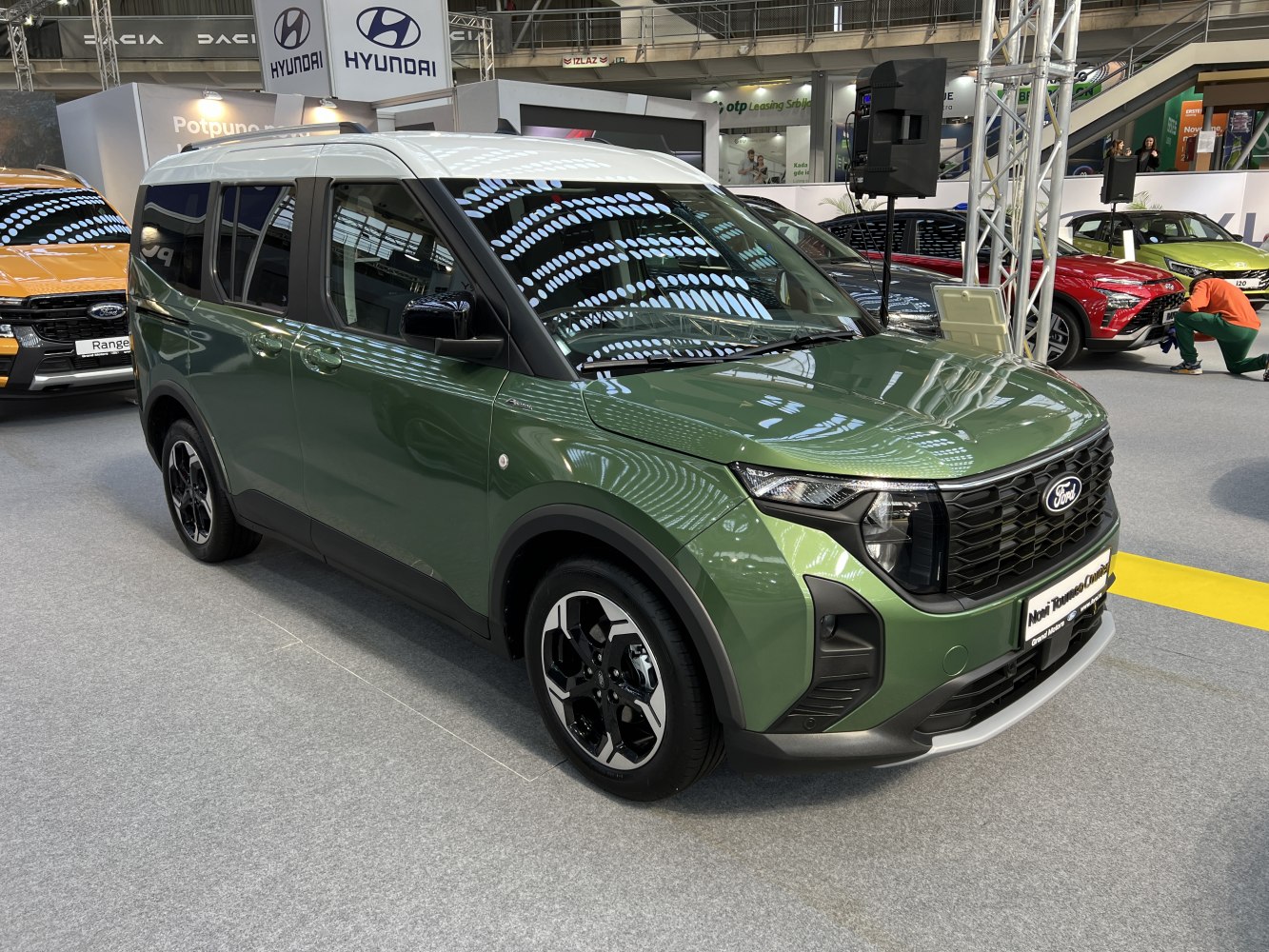 Front left side view of green and white two-tone multi-purpose vehicle
