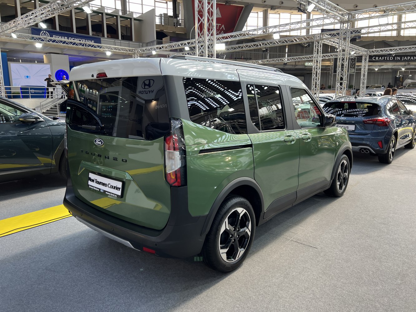 Rear three-quarter view of modern two-tone compact van with alloy wheels