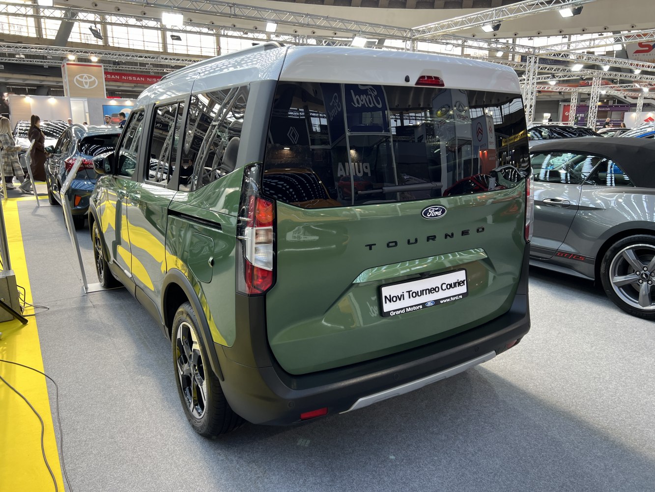 Rear view of a modern compact MPV with tinted windows and distinctive taillights