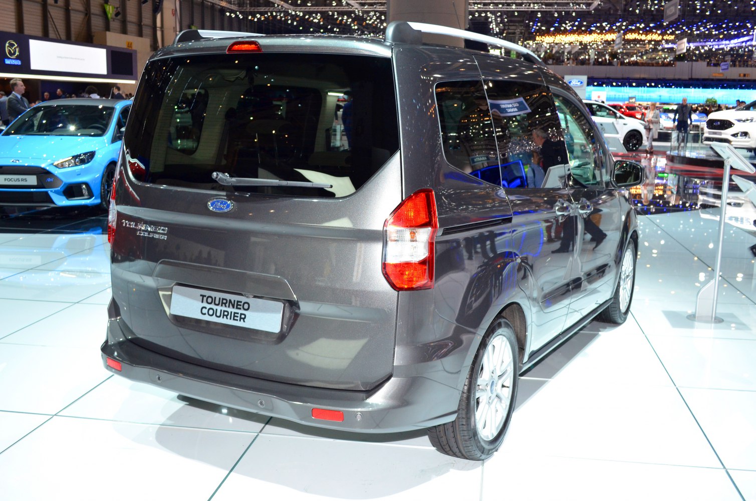 Compact van rear with large window, tail lights, roof rails, sliding door