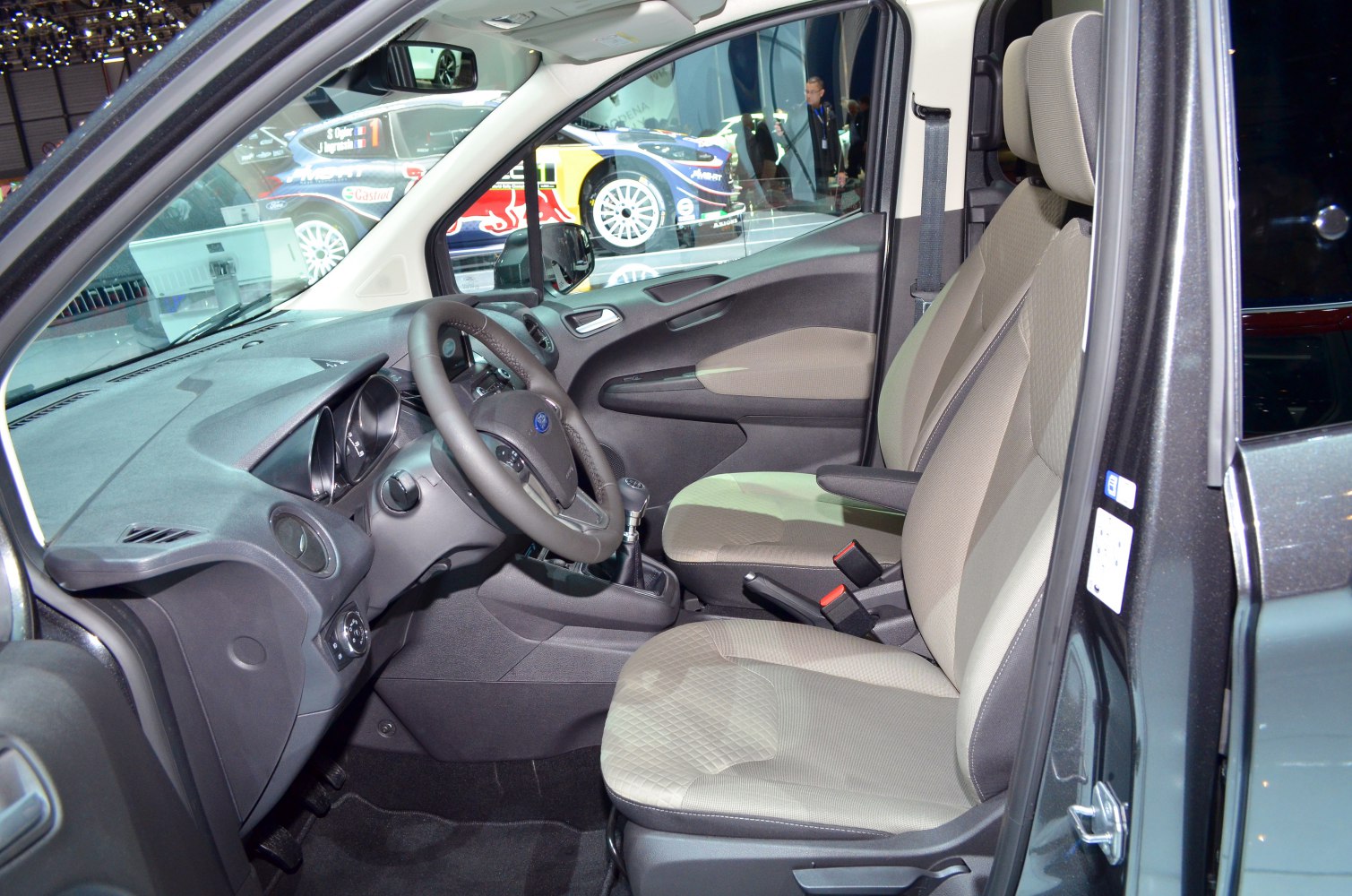 Front seats, dashboard, and steering wheel with manual gear stick