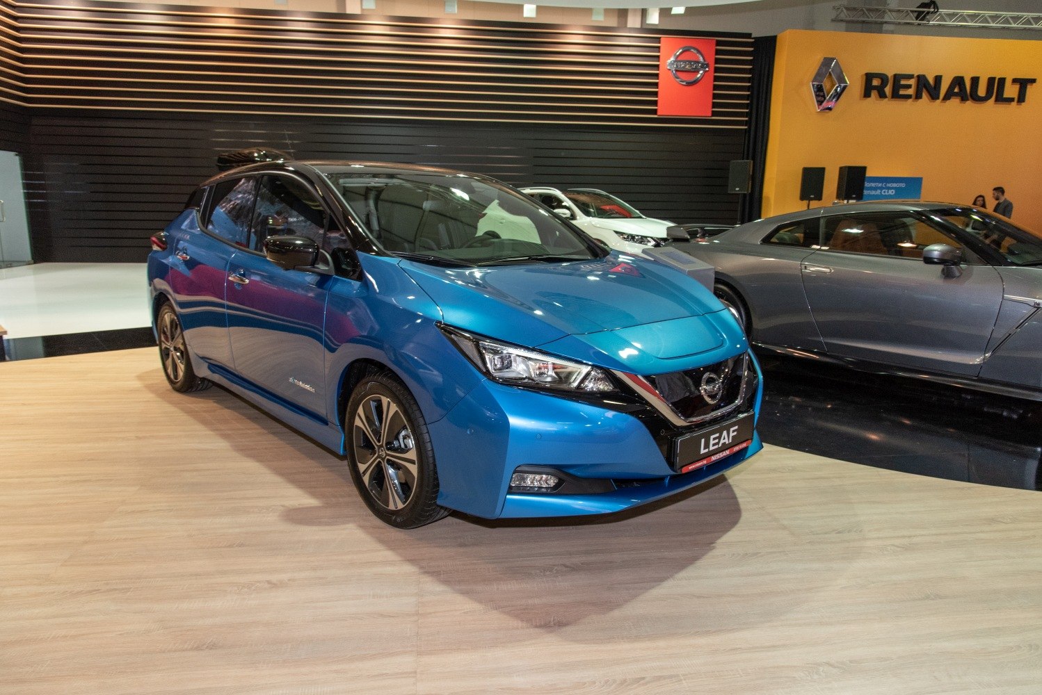 Blue electric hatchback with sharp headlights and aerodynamic front design