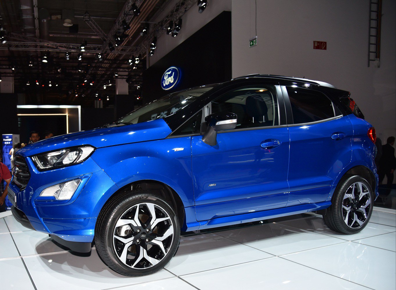 Blue compact SUV with sleek side profile and multi-spoke alloy wheels