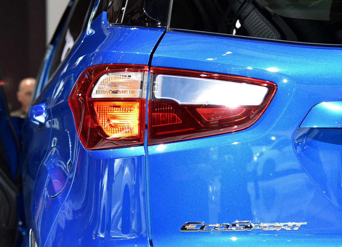 Close-up of rear taillight and EcoSport badge on blue vehicle
