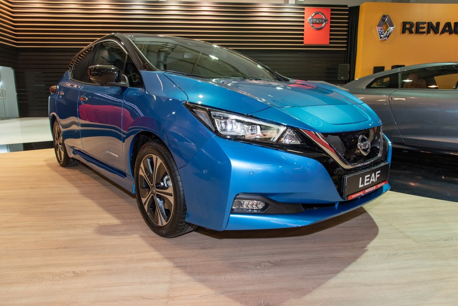 Front side view of electric hatchback with LED headlights and aerodynamic body