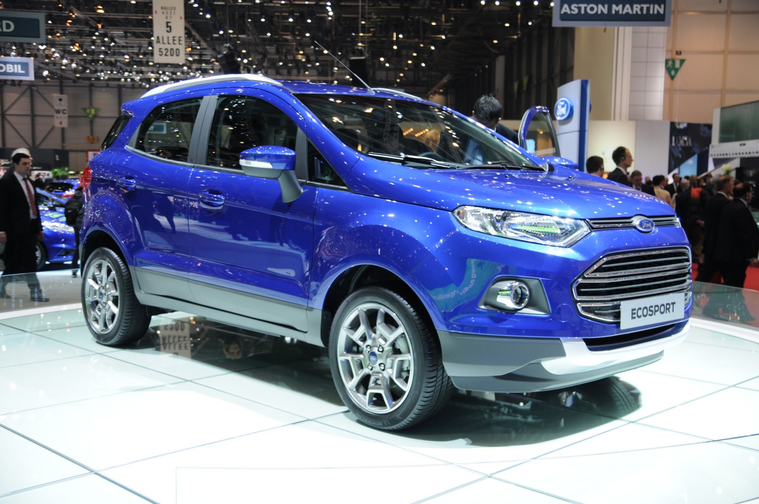 Blue compact SUV with alloy wheels and LED headlights, side and front view