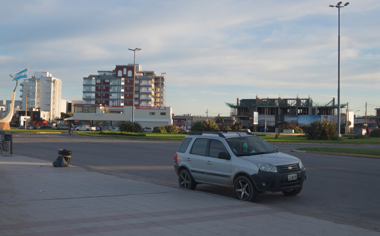 Compact silver SUV parked on urban street with roof racks and alloy wheels