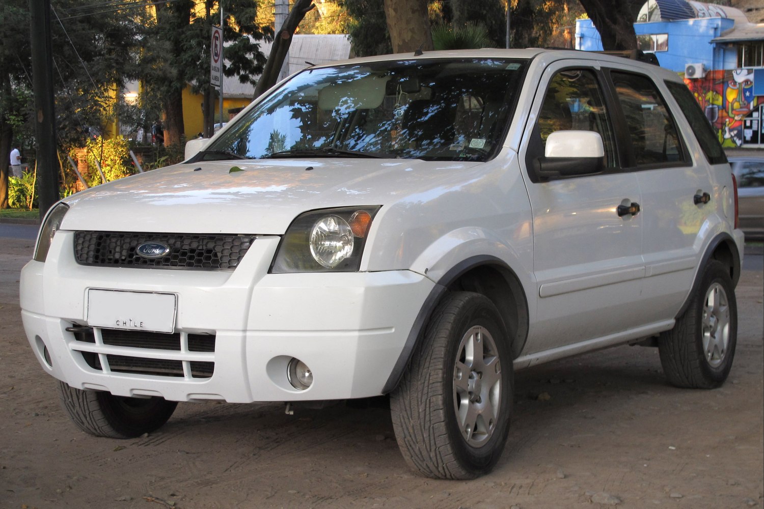 Compact white SUV front-side with prominent grille and headlights